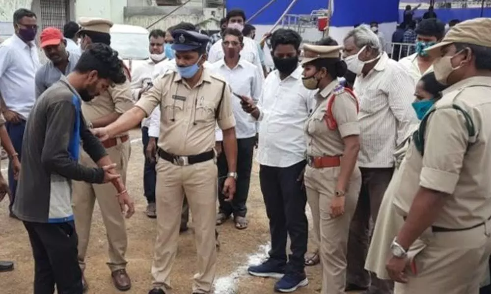 Police prevent sacked employee K Anil Kumar at volunteers’ felicitation venue in Srikakulam on Thursday