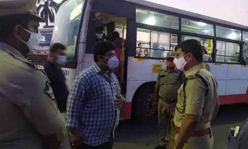 Police officials creating awareness among people on importance of wearing mask in Vijayawada on Thursday