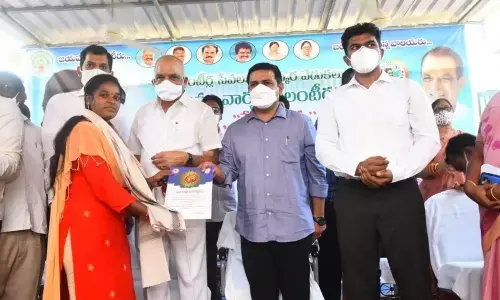 District Collector V Vinay Chand presenting awards to volunteers for their exemplary service in Elamanchili on Thursday