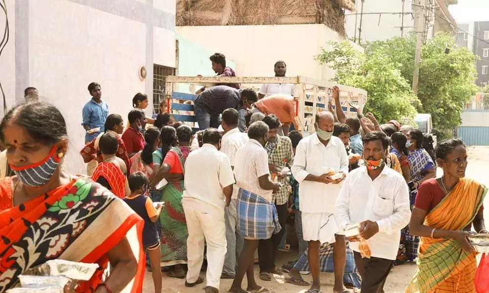 Food packets being distributed to outsiders in Tirupati on Saturday