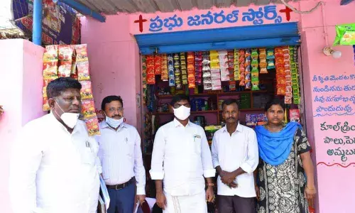 NSCFC Chairman M Venkateshan in (dhoti) with loan beneficiary in Anantapur on Sunday