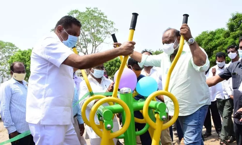 BC Welfare Minister G Kamalakar and Mayor Y Sunil Rao doing exercise after inaugurating open gym in Karimnagar city on Tuesday