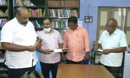 Gade Sasidhar going through the text on palm leaf manuscripts in Saraswata Niketanam at Vetapalem