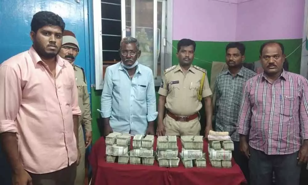 SEB Circle Inspector N Lakshmi Durgaiah with seized cash at Panchalingala border check post on Thursday