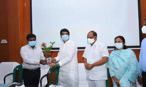 Collector Gandham Chandrudu welcomes Finance Minister Bugganna Rajendranath Reddy with a sappling in Anantapur on Thursday. Minister Sankara Narayana and joint collector Siri also seen.