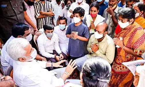YSRCP Rajya Sabha member V Vijayasai Reddy with the family members of Vijay at Sivajipalem in Visakhapatnam on Saturday