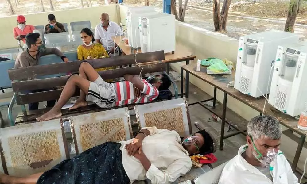 Covid patients receiving oxygen support while waiting for their turn to get a bed at GGH Ongole on Sunday