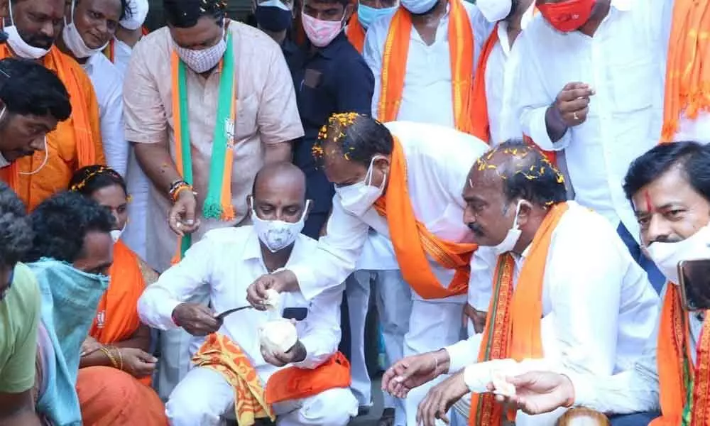 BJP State chief and MP Bandi Sanjay Kumar removing ice apples from palm fruit during election campaign in Khammam on Sunday