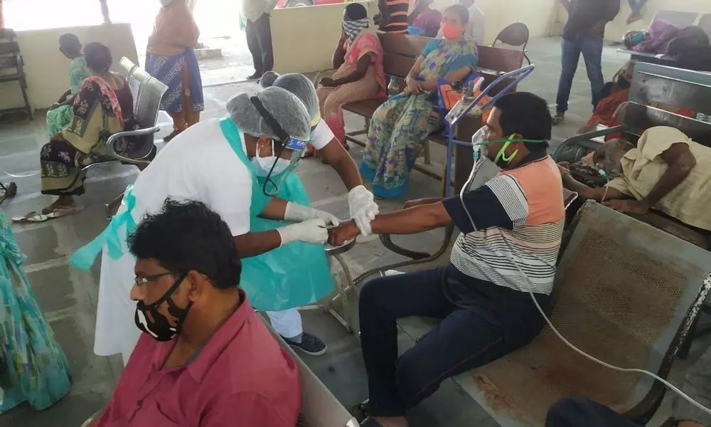 Doctors offering treatment at Covid OP in GGH Ongole on Monday