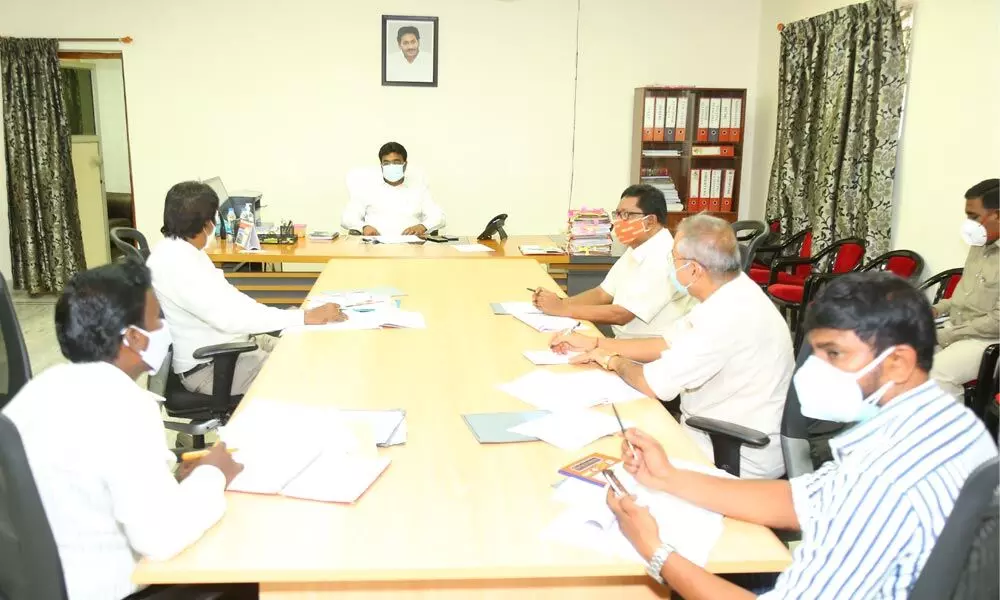 Joint Collector JV Murali conducting a meeting with the DRDA and PDCC Bank officials in Ongole on Monday