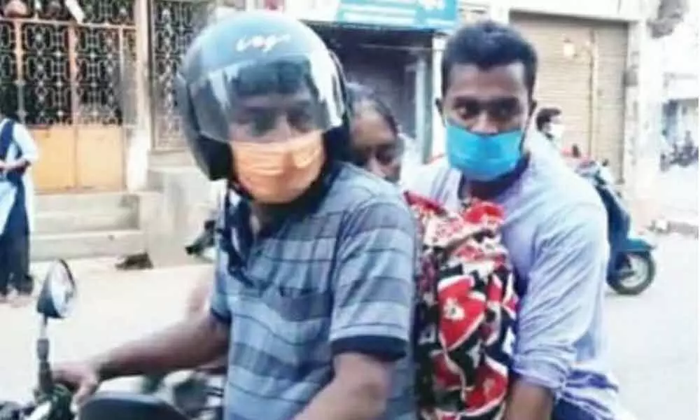 A video grab of womans body being taken on a motorcycle in Palasa on Monday