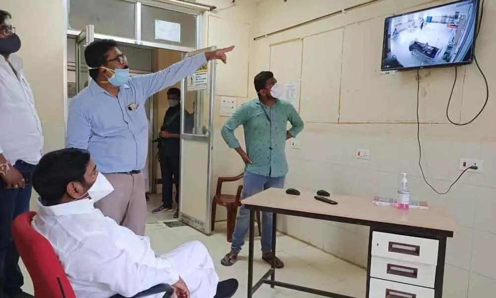 Minister Jagadish Reddy interacting with Covid-19 patients through video conference in Suryapet on Wednesday