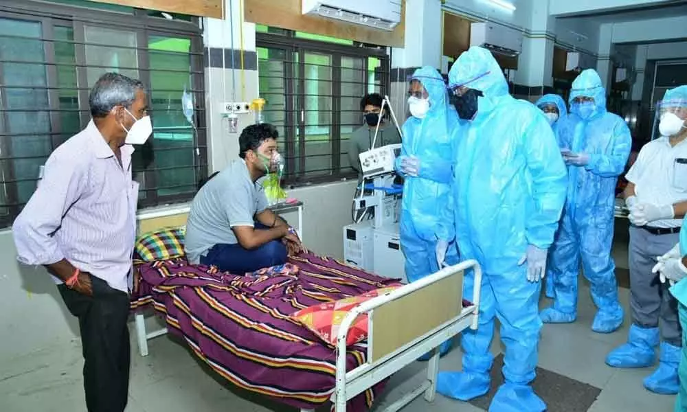 Minister for Panchayat Raj Errabelli Dayakar Rao speaking to Covid-19 patients at the MGM Hospital  in Warangal on Wednesday.