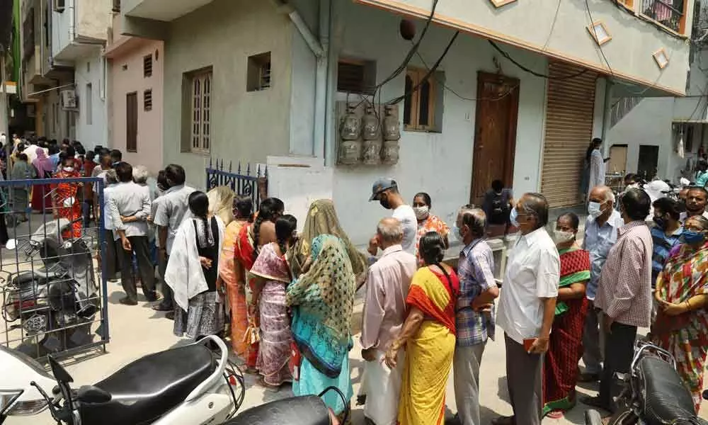 A large number of people wait for their turn for second dose of vaccination at Scavengers Colony in Tirupati on Wednesday