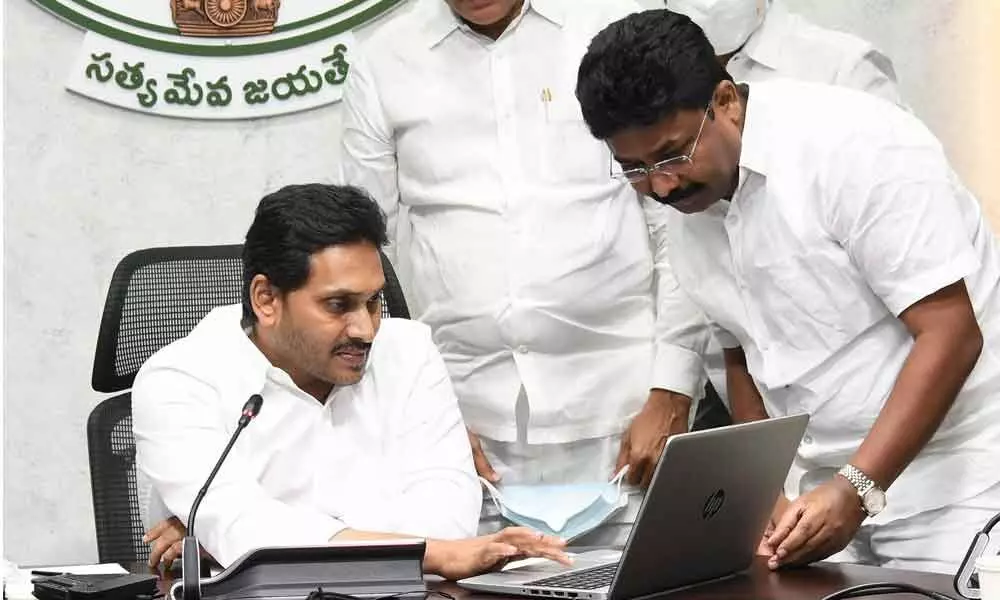 Chief Minister Y S Jagan Mohan Reddy formally releasing money into bank accounts of mothers under Jagananna Vasathi Deevena scheme at this camp office in Tadepalli on Wednesday. Education Minister A Suresh is also seen.