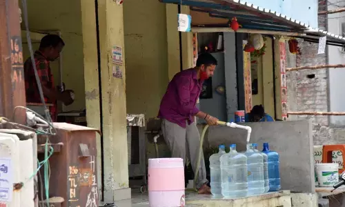 Water being filled into cans at a water plant in Rajamahendravaram