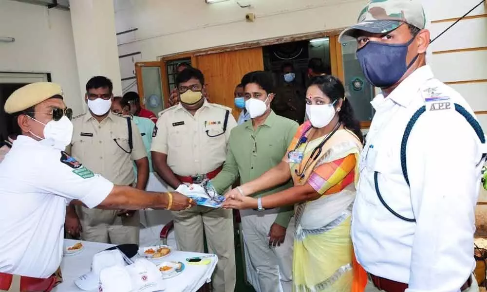 Medical kits being distributed to traffic police personnel in Ongole on Friday
