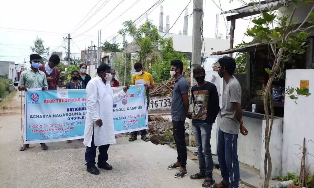 Dr Harsha Preetham Dev explaining about coronavirus in a rally organised by NSS volunteers in Ongole on Friday