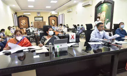 District Collector Vivek Yadav participating in a videoconference in Guntur on Friday. Joint Collectors P Prasanti and K Sridhar Reddy also seen