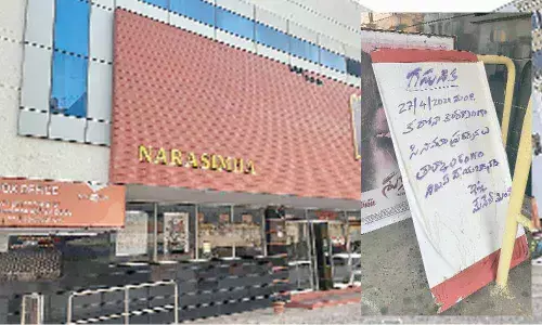 A twin-theatre that closed down in Visakhapatnam amid growing number of coronavirus cases; A cinema hall with a signboard indicating the  suspension of film screening in Visakhapatnam.  Photo: Vasu Potnuru