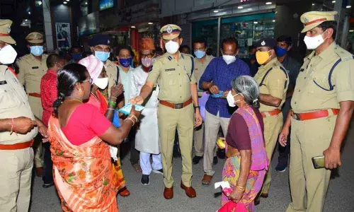 Police personnel distributing masks to people in Karimnagar on Friday