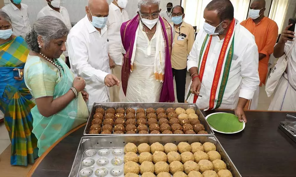 TTD chairman and other officials look  at the Laddu Naivedyam made of organic farm produce at Srivari Potu (kitchen) at Tirumala on Saturday