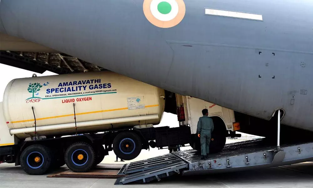 Empty oxygen tankers being loaded onto Indian Air Force cargo plane at Vijayawada airport on Saturday