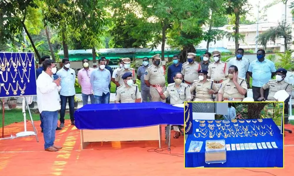 Police Commissioner B Srinivasulu and other officers with the recovered gold articles at a press meet in Vijayawada  on Saturday