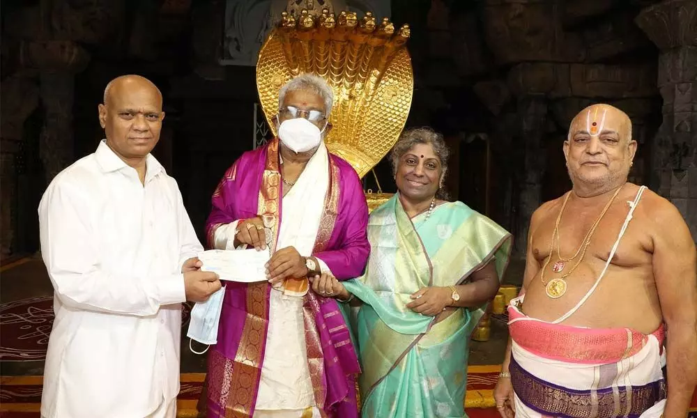TTD Chairman Y V Subba Reddy handing over a cheque for Rs 5 lakh to Additional EO A V Dharma Reddy towards his donation to TTD activities at Tirumala on Saturday