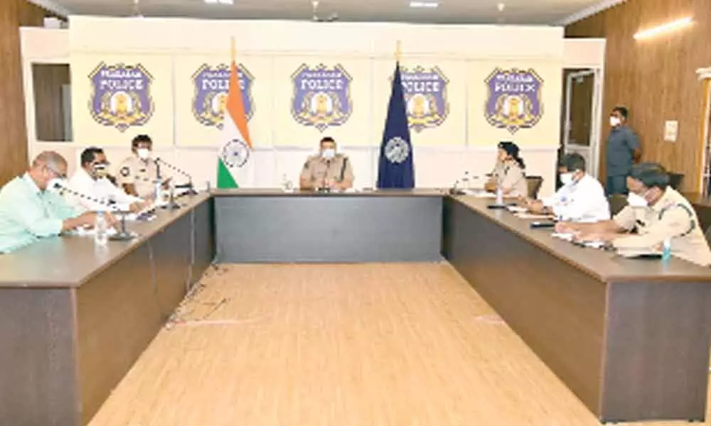 SP Siddharth Kaushal interacting with the officers and personnel of the Poice department through video conference  from Ongole on Sunday
