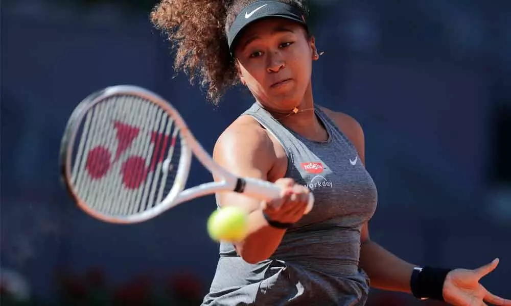 Naomi Osaka of Japan returns the ball to Karolina Muchova of the Czech Republic during their match at the Madrid Open on Sunday