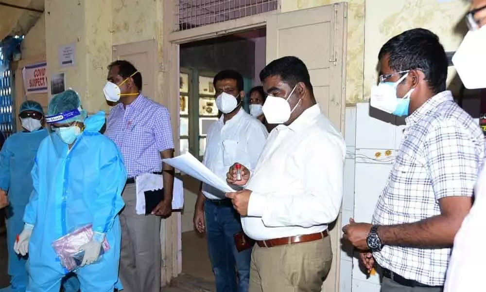 Collector Veera Pandiyan looking at the duty chart of doctors at Old Gynaecology ward in Government General Hospital in Kurnool on Monday