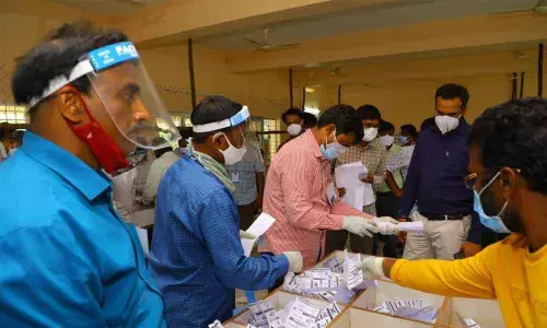 Election staff counting votes at SR&BGNR College in Khammam on Monday