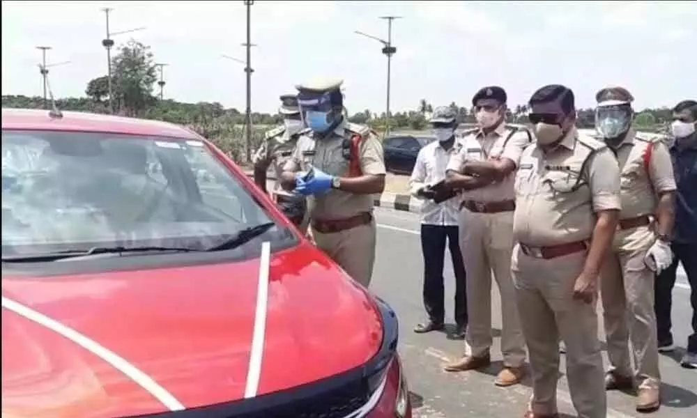 Krishna district Superintendent of Police M Ravindranath Babu along with other police officials at the Garikapadu check post on Thursday
