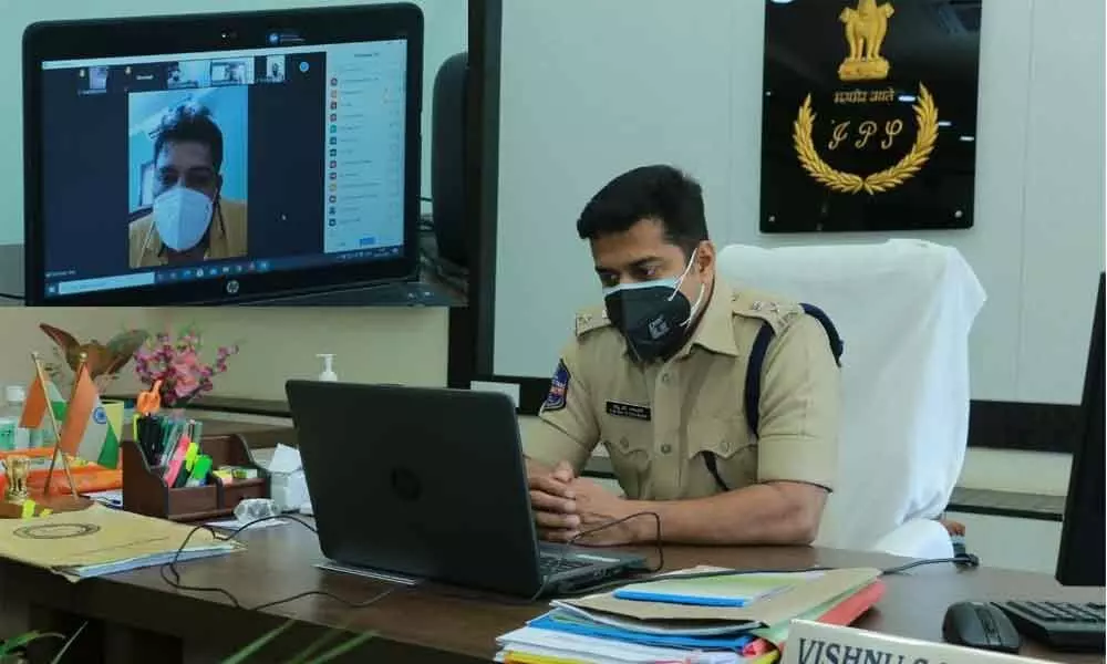 Police Commissioner Vishnu S Warrier interacting with police personnel, who were tested Covid positive, through a video conference at his office in Khammam on Thursday