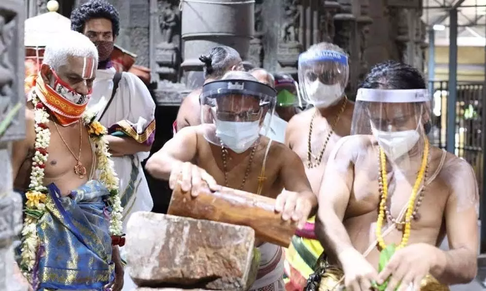 Priests grinding sandalwood paste ahead of the annual Chandanotsavam in Simhachalam on Friday