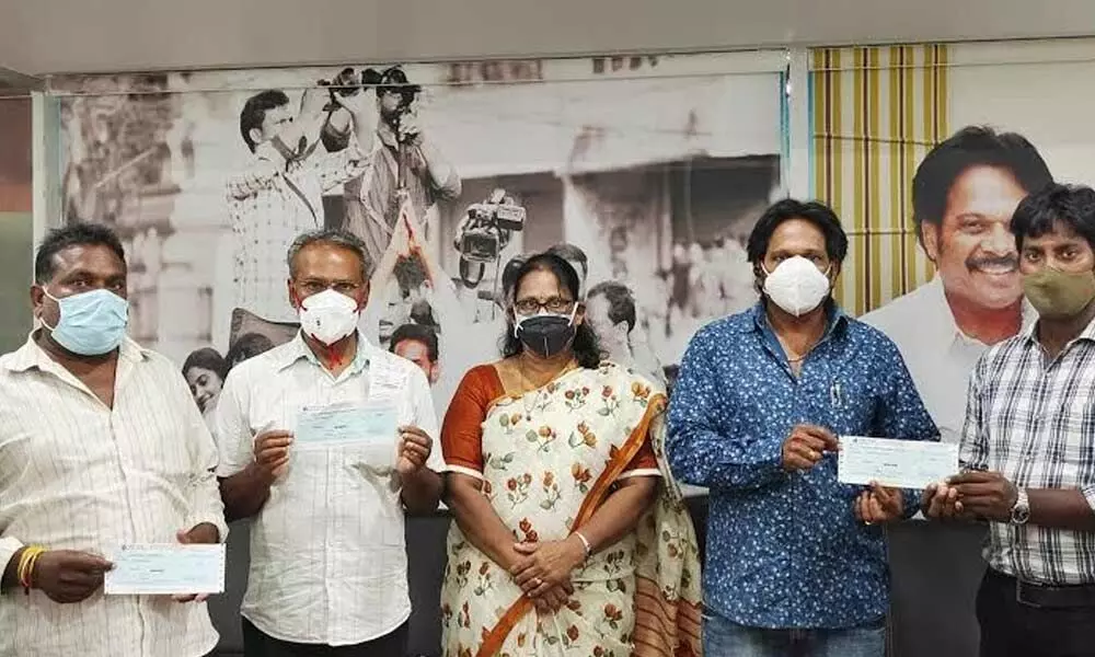 MP MVV Satyanarayana giving away cheques to the victims suffering from various ailments at his office in Visakhapatnam on Friday