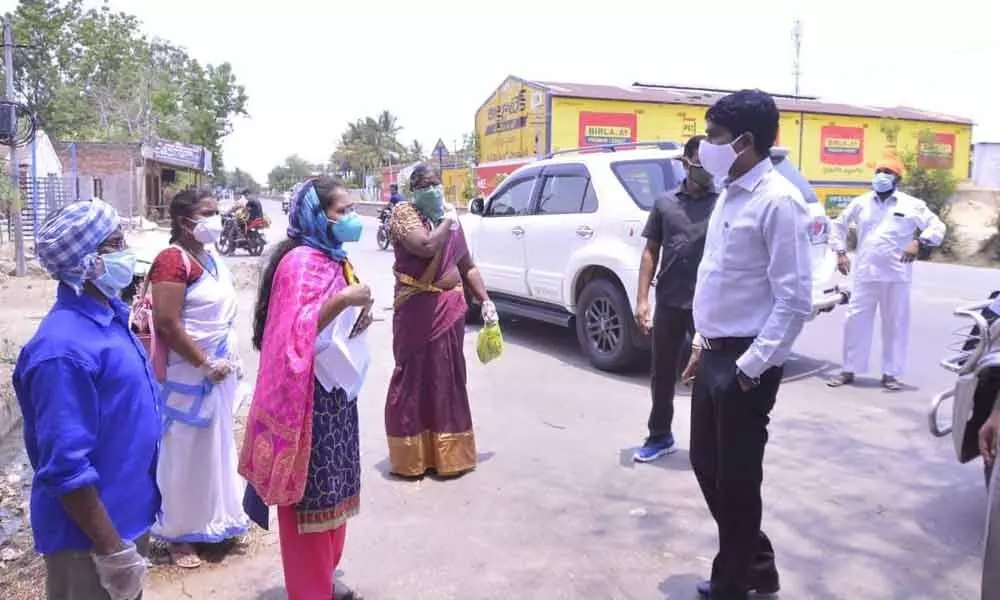 District Collector C Narayana Reddy interacting with door-to-door survey team at Dharmaram B on Friday