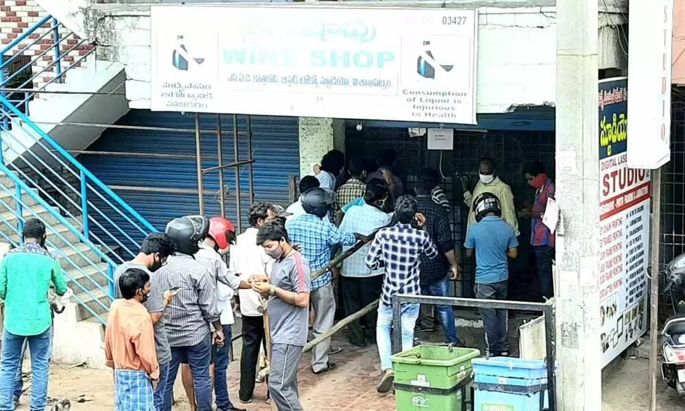Tipplers queuing up at a wine shop during the period of curfew relaxation in Visakhapatnam Photo Vasu Potnuru