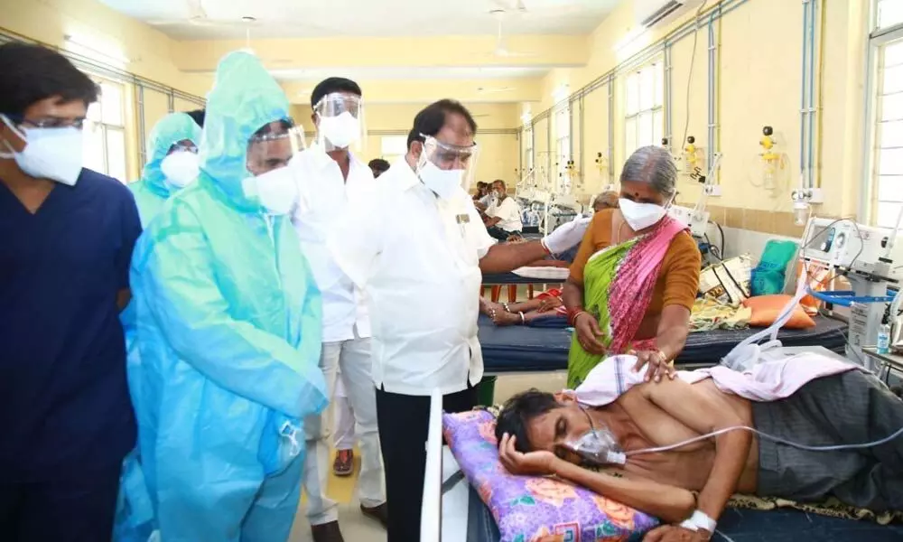 MLA K Bhupal Reddy consoling an attendant of a corona patient during his visit to isolation ward at District Government Hospital in Nalgonda on Saturday