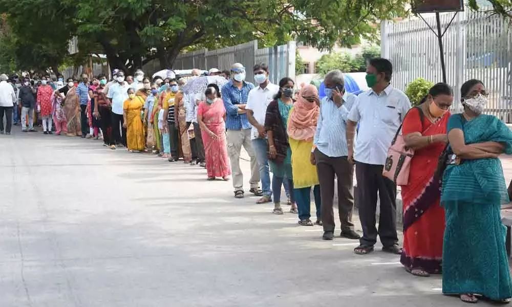 People standing in queue lines to get vaccinated in Tirupati on Saturday