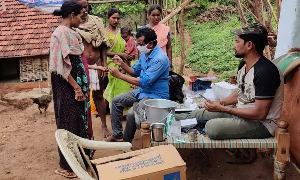 Medical and Health personnel conduct tests on the sick villagers during a medical camp in a tribal hamlet in Anantagiri mandal on Monday
