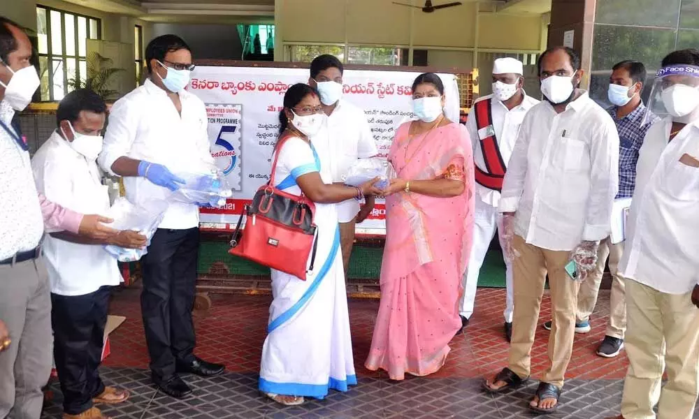 Mayor G Hari Venkata Kumari distributing face shields, masks, hand gloves and sanitisers to frontline workers  in Visakhapatnam on Monday