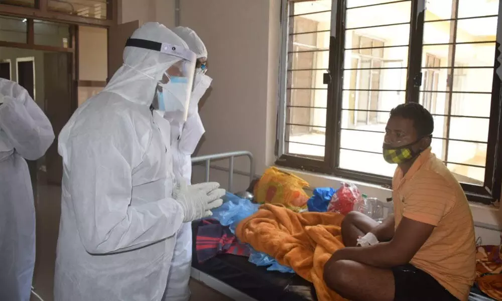 Donning a PPE kit, ITDA Project Officer S Venkateswar interacting with a Covid patient at the District Hospital, Paderu in Visakhapatnam