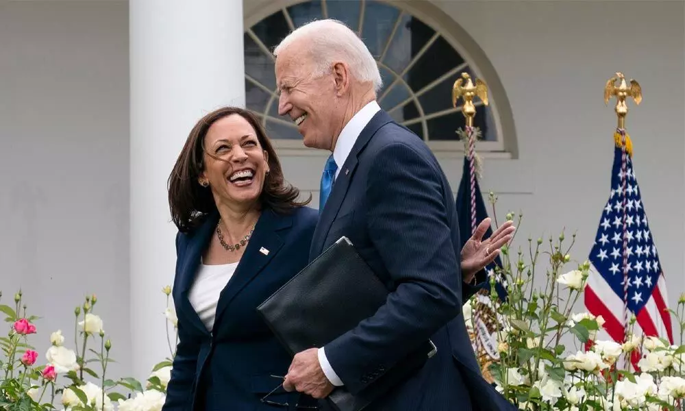 Vice-President Kamala Harris and President Joe Biden smile and walk off after speaking about updated guidance on mask mandates, in the Rose Garden of the White House on Thursday