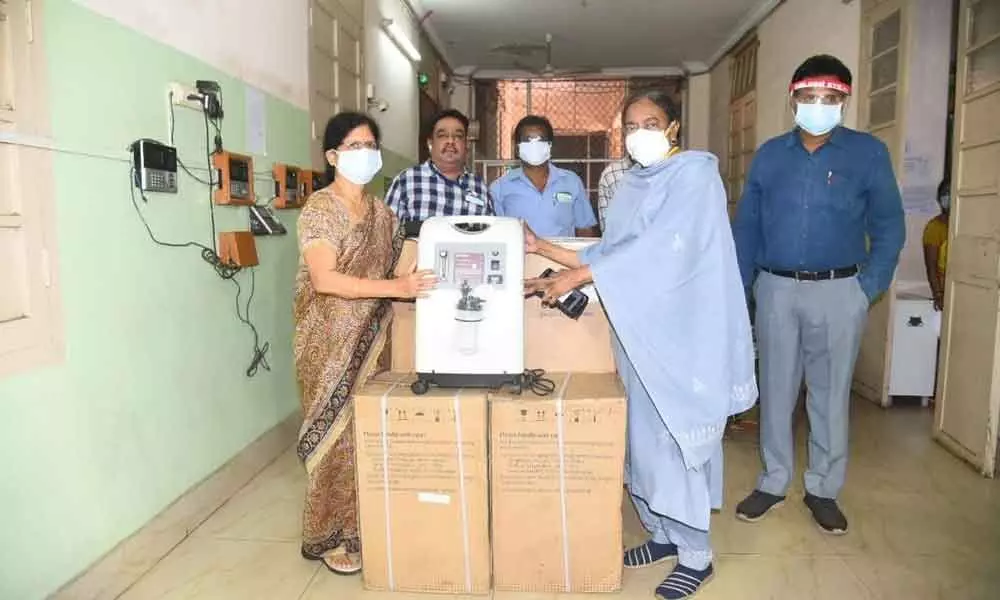 Representative of Suraksha handing over oxygen concentrators to KGH Superintendent  P Mythili as a part of the donation in Visakhapatnam on Saturday