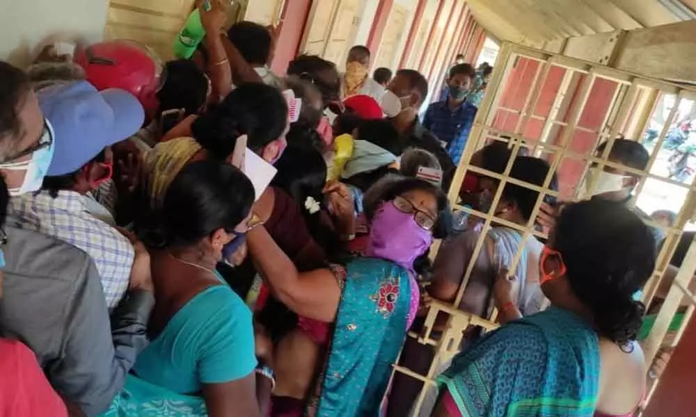 People gather at the vaccination centre at NTR Municipal High School in Srikakulam city