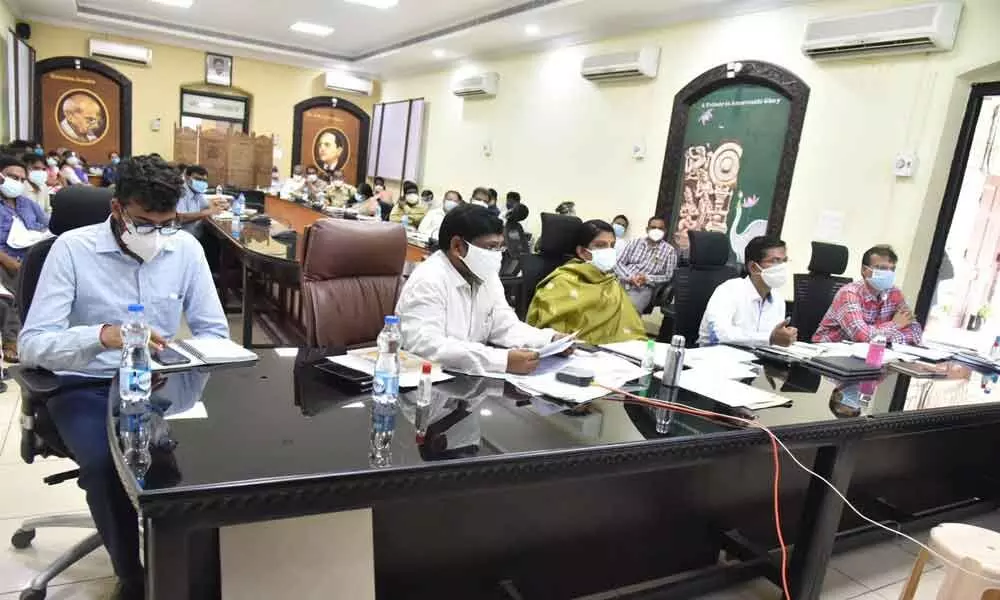 District Collector Vivek Yadav speaking to Sub-Collectors, Municipal Commissioners and tahsildars over a video-conference on measures to contain Covid-19 from the Collectorate in Guntur city on Saturday. Joint Collectors  A S Dinesh Kumar and  P Prasanti are also seen.