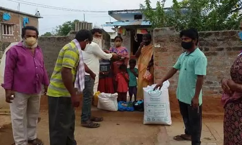The members of WhatsApp group distributing rice and other essential items to corona patients in Mothkur on Saturday