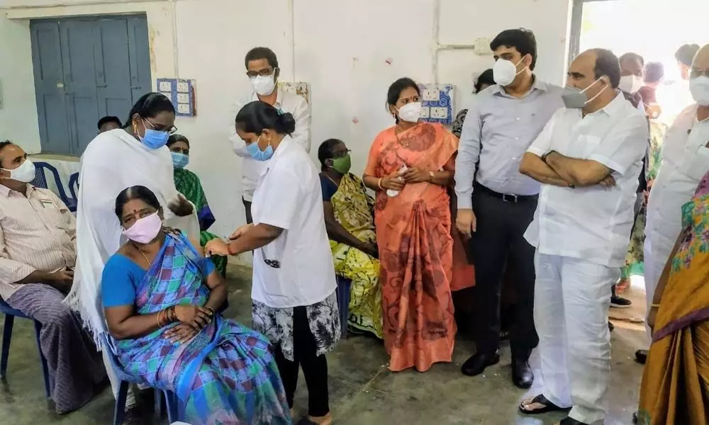 Minister Balineni Srinivasa Reddy observing the vaccination process at PVR Boys High School in Ongole on Sunday